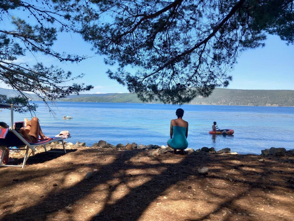 A family from Slovenia parked the camper van in the shade and enjoyed the beach in Mali Lošinj, Croatia