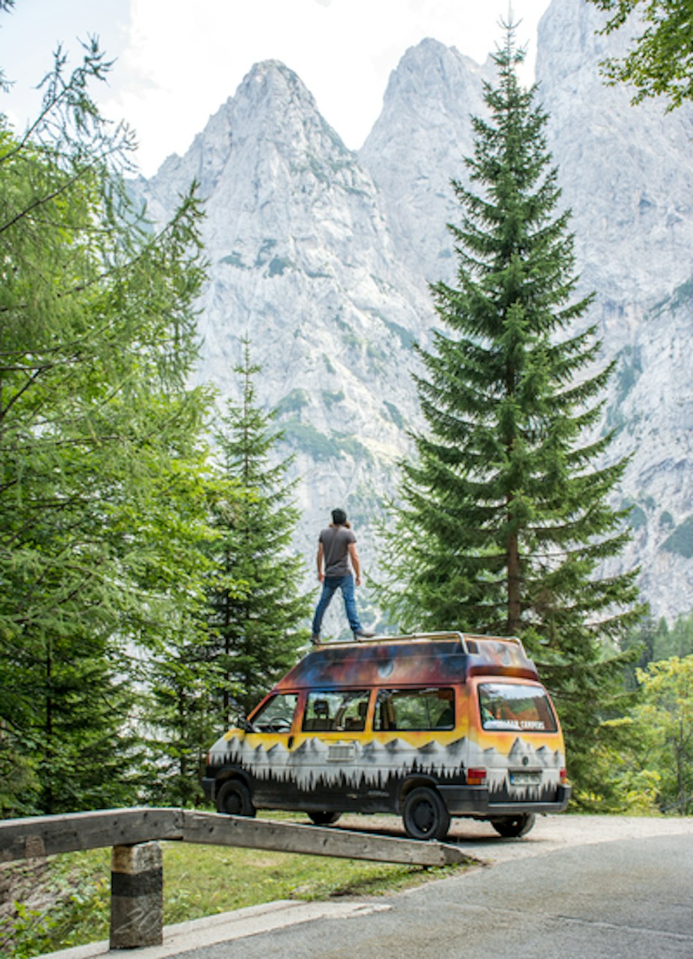Man standing on Jerry campervan in Triglav National Park