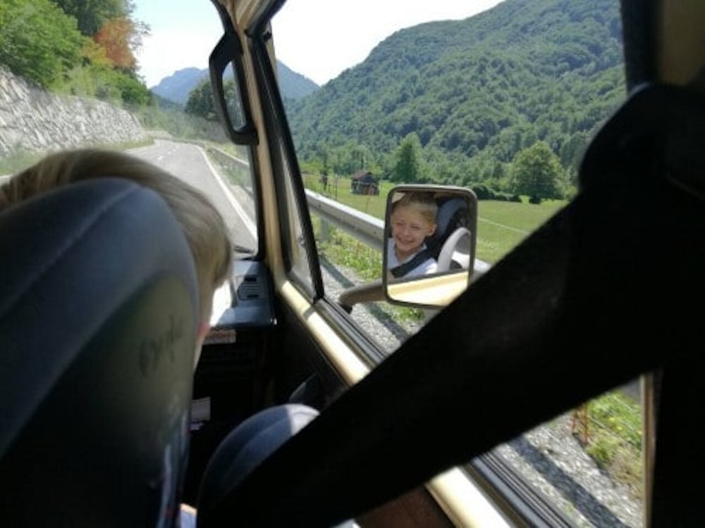 Kid enjoying the ride with old school bus from Balkan Campers