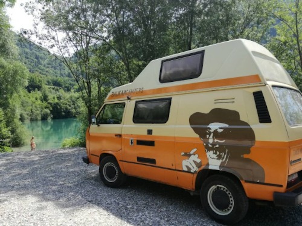 VW Campervan parked next to Soča river, Slovenia