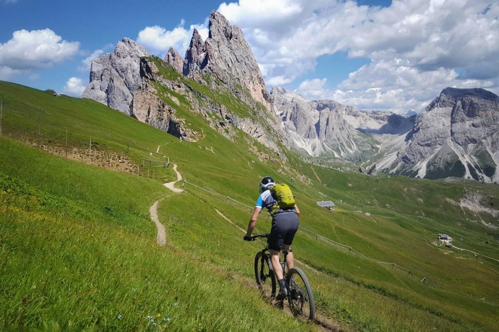 A men biking in beautiful Dolomites, Italy