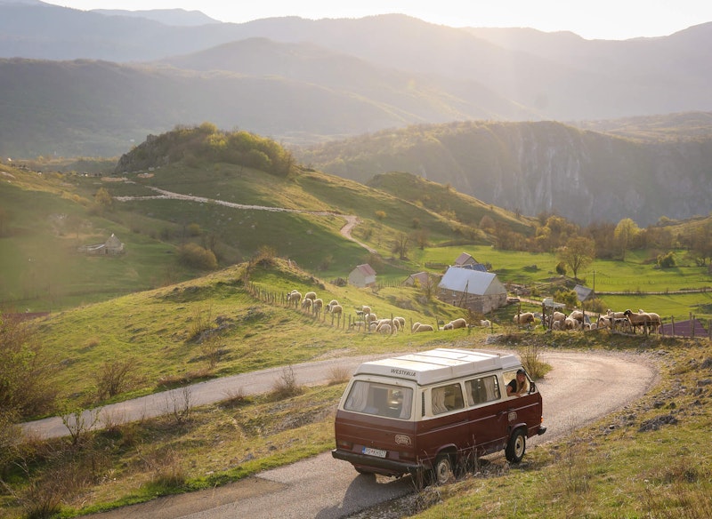 Person sitting in a VW t3 from Balkan Campers in the mountains of Montenegro