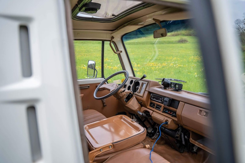 Three seats infront of Nissan Datsun Campervan