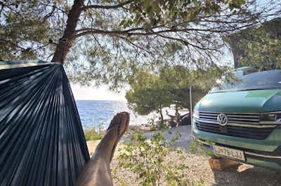 VW Campervan, flip flops and view of the beach