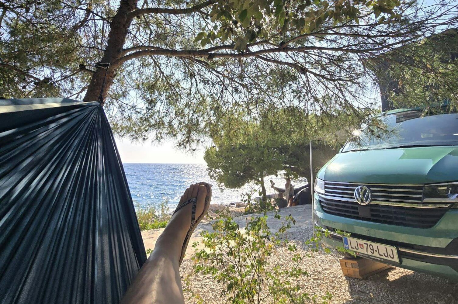 VW Campervan, flip flops and view of the beach