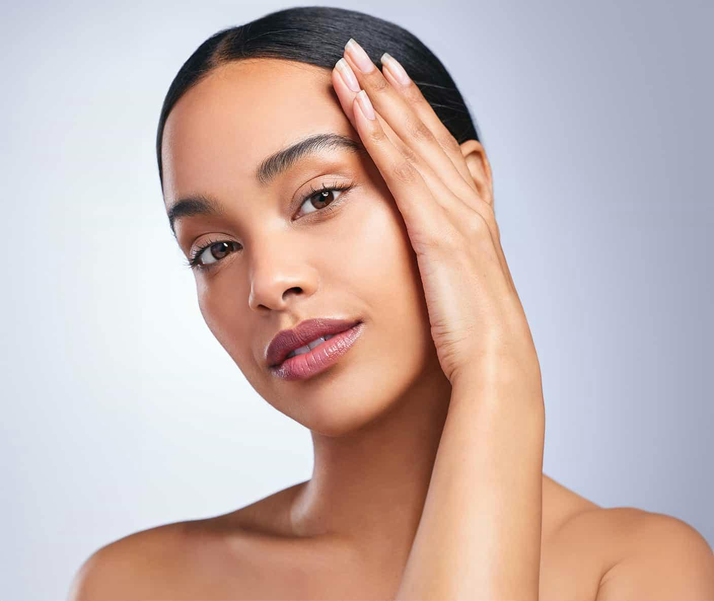 Woman smiling and touching face