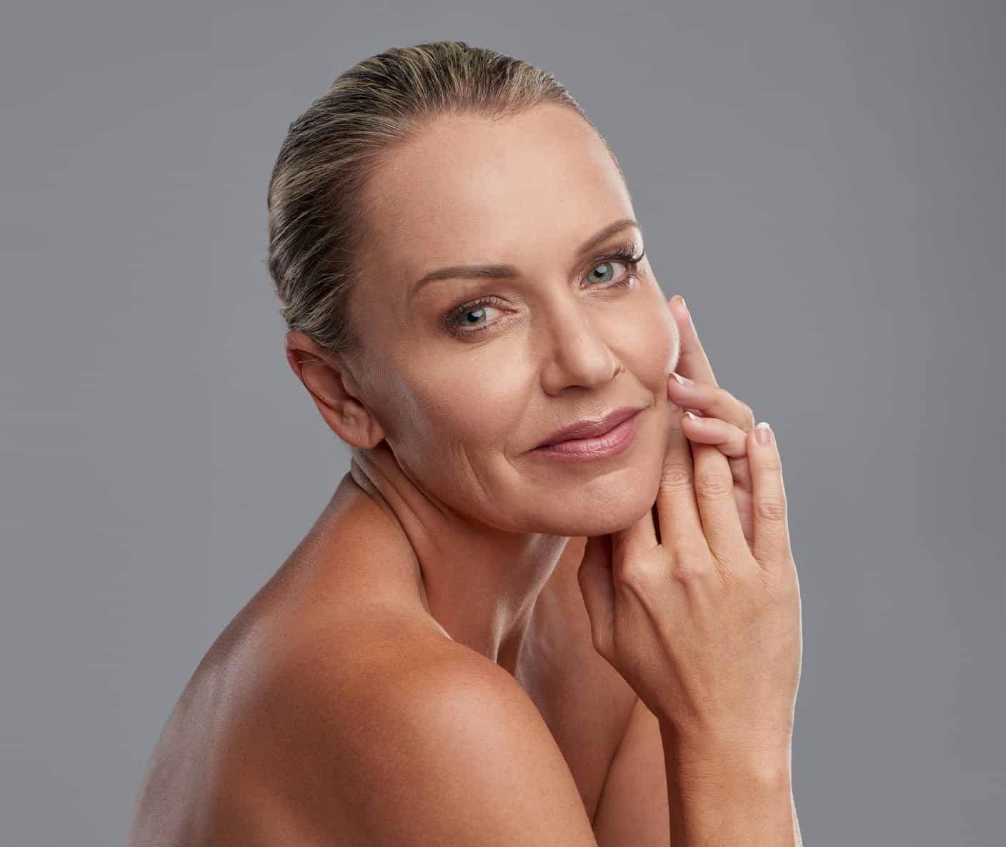 Woman smiling touching face