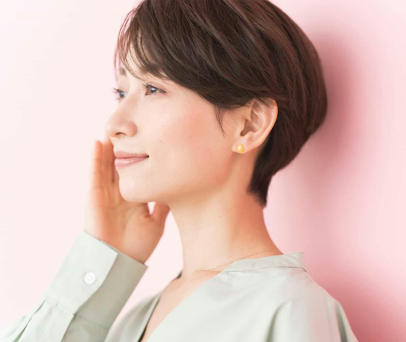 Woman smiling and touching face