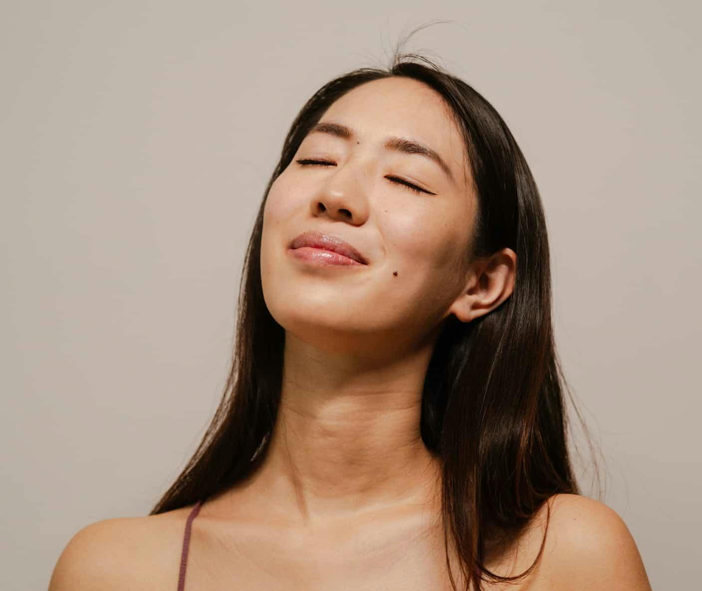 Woman smiling with eyes closed