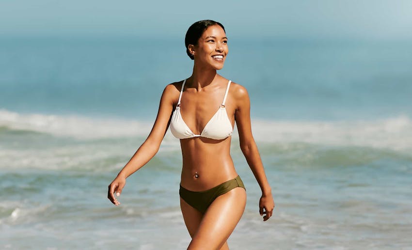 Woman smiling walking on the beach
