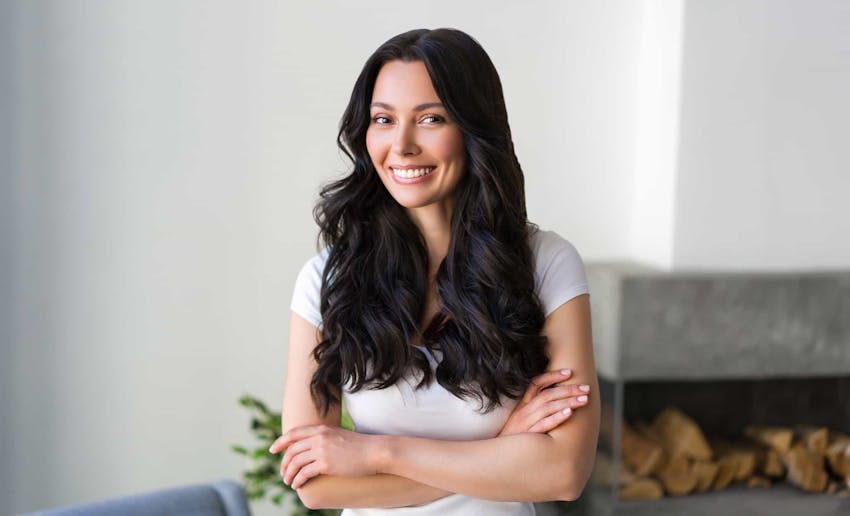 Woman smiling with arms crossed