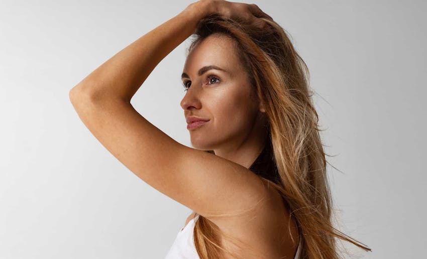 Woman posing with hand holding hair