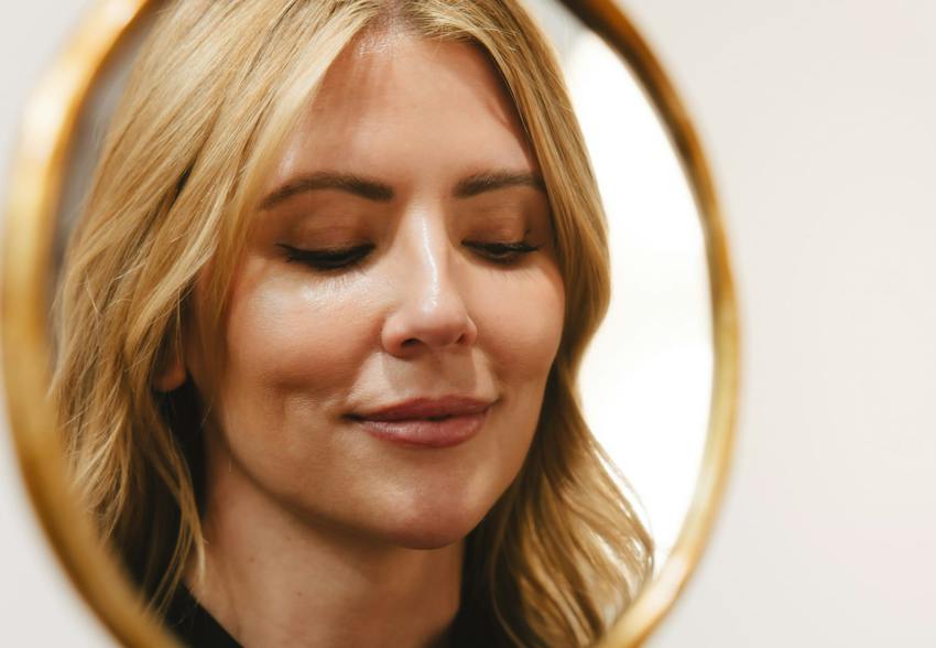 Woman Looking at Her Reflection