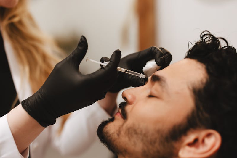 man receiving facial injections