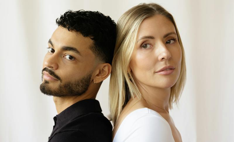 man and women posing back to back