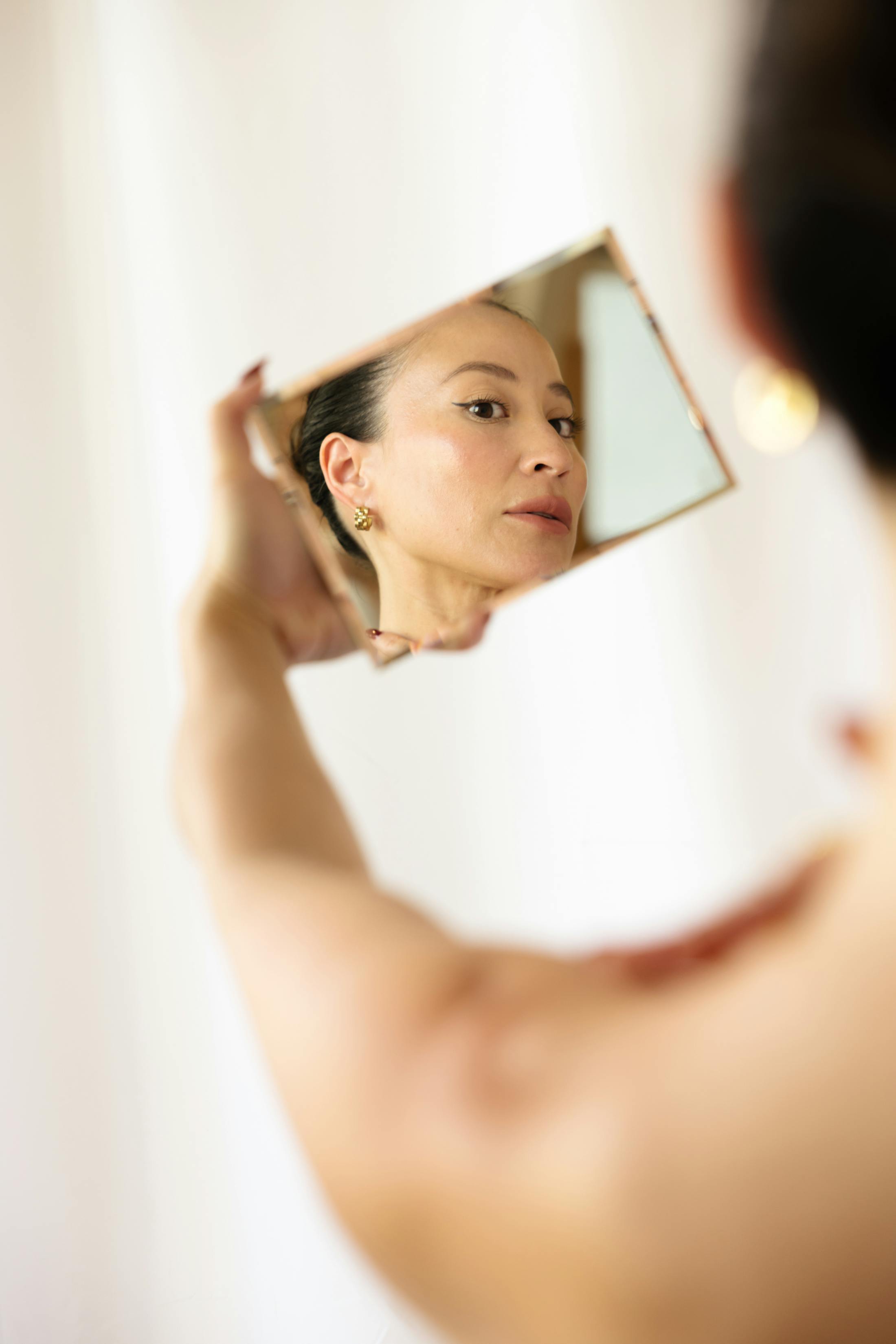 woman looking at herself in a mirror