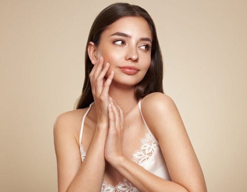 woman touching face smiling