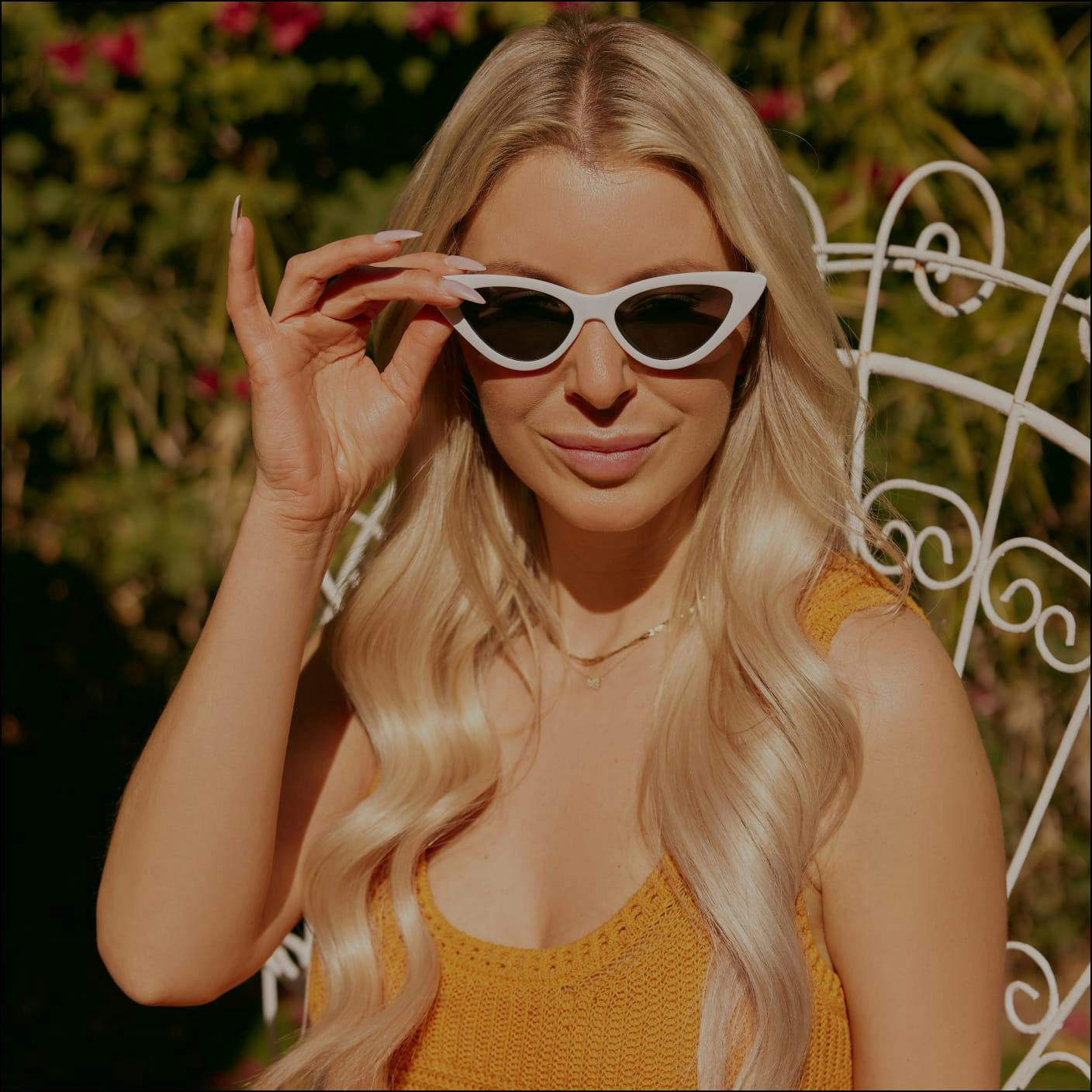 woman with long blonde hair wearing white sunglasses