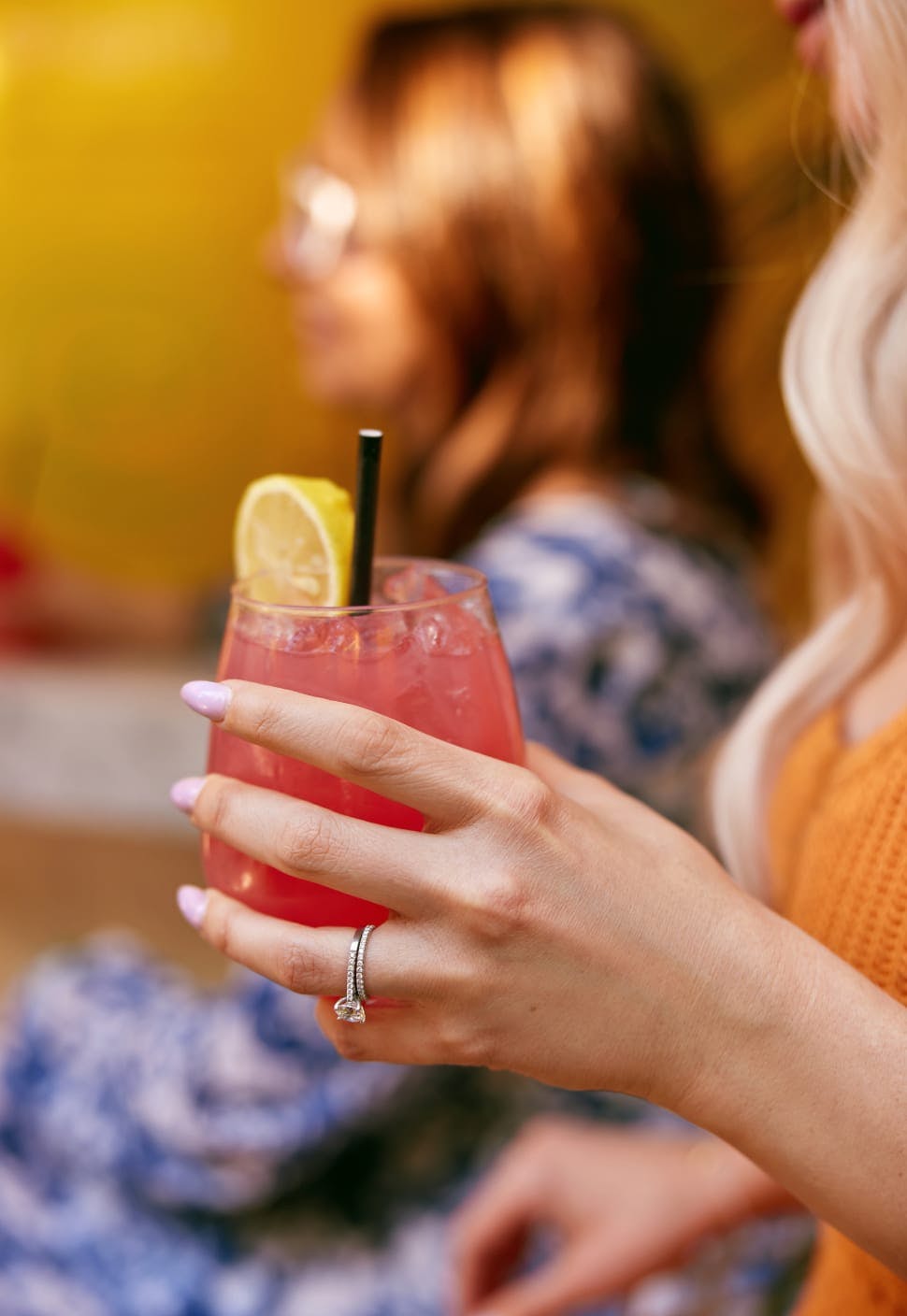 woman holding red drink