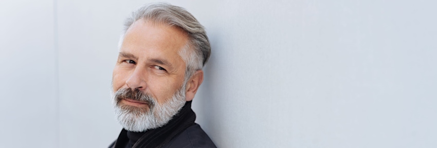 man with white hair looking to his left