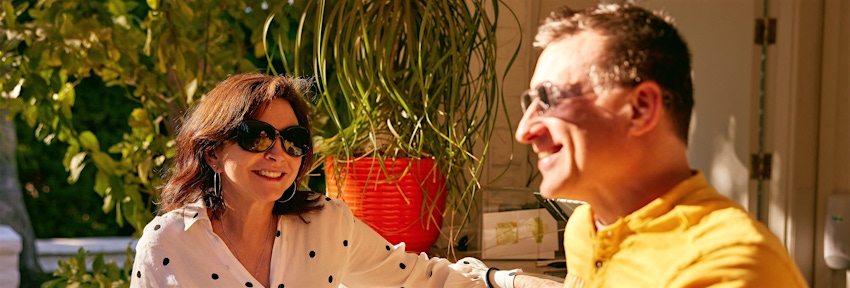 man and woman sitting in sun together