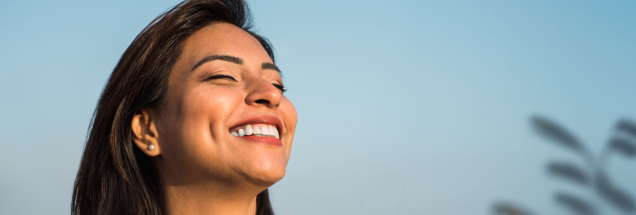woman smiling as the sun hits her face
