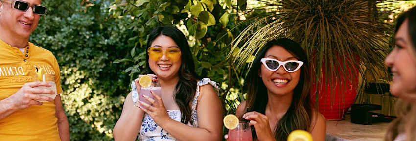 4 people drinking and smiling