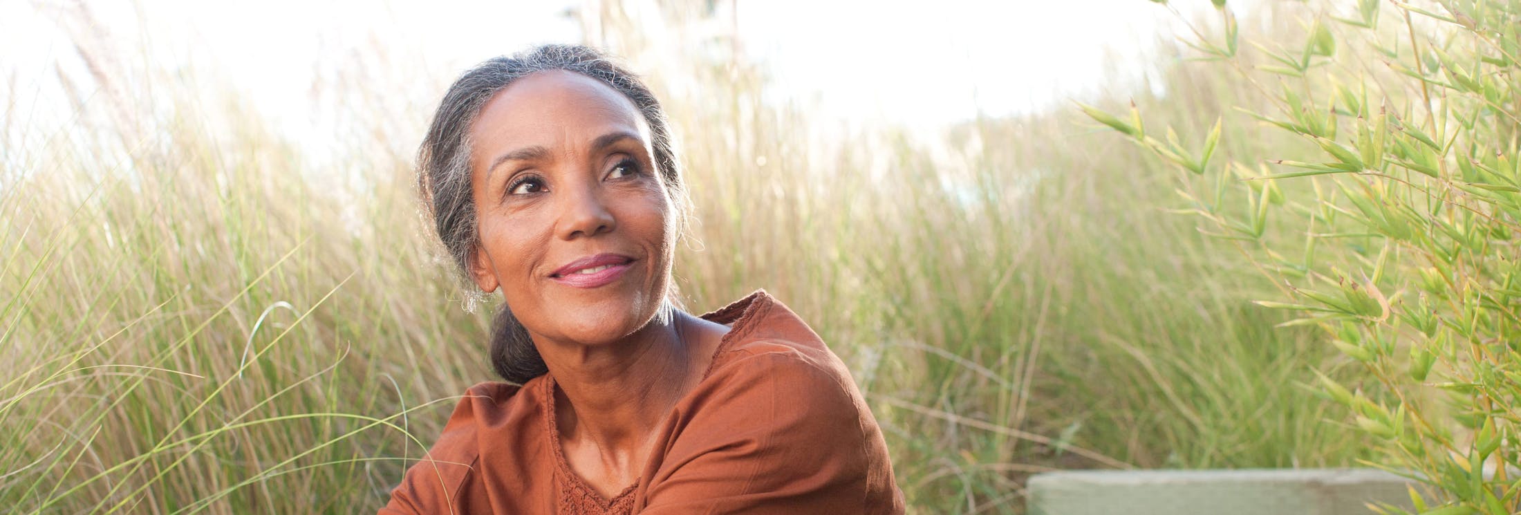 older woman looking to the right and smiling