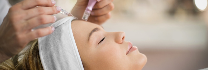 woman side angle of her getting microneedling done