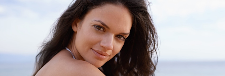brunette woman looking over her shoulder