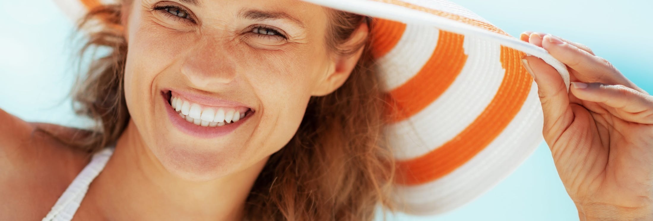 woman with striped hat smiling