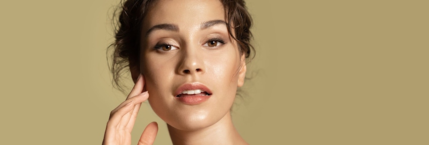 woman touching her cheekbone