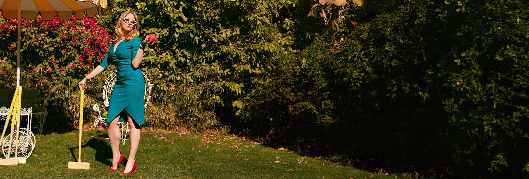 woman holding croquet ball and mallet