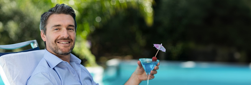 man holding drink and smiling