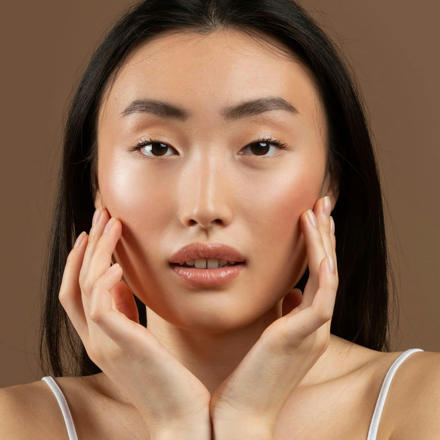 woman touching the sides of her face