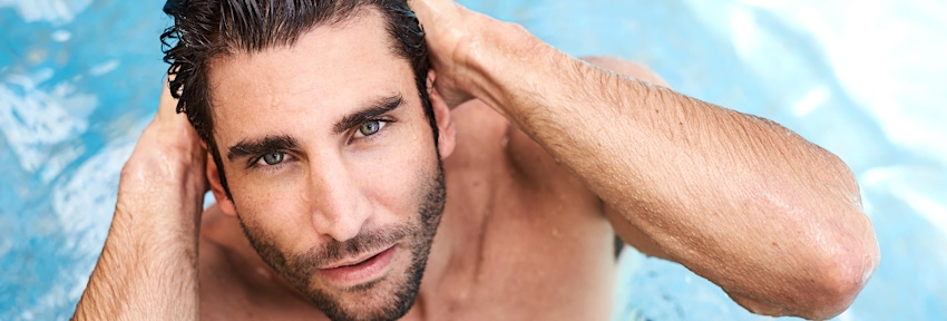 Man in the pool lookng up at camera