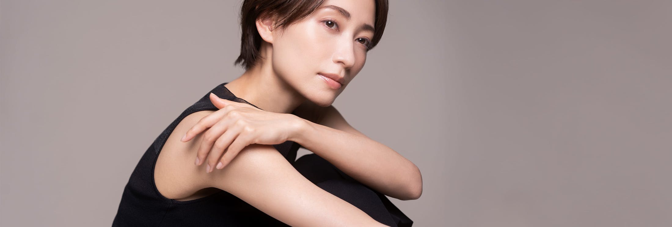 person posing with hand on shoulder