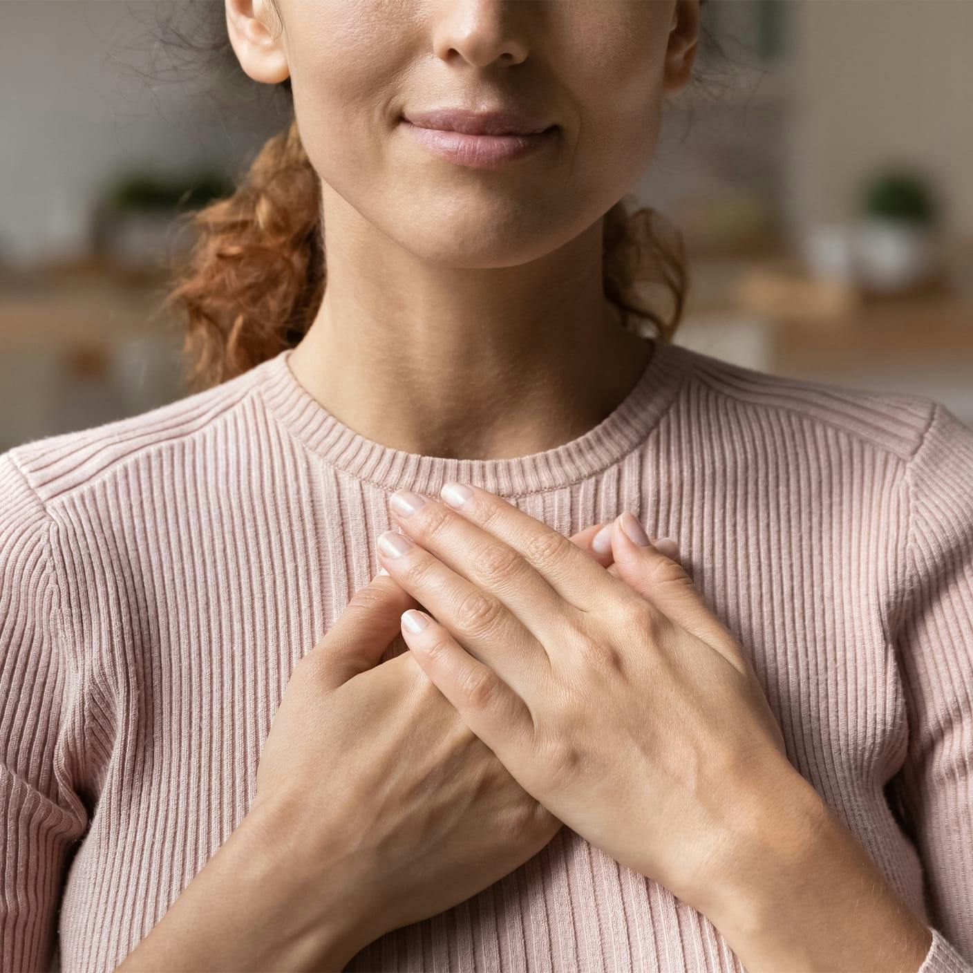 Person holding hands up to chest