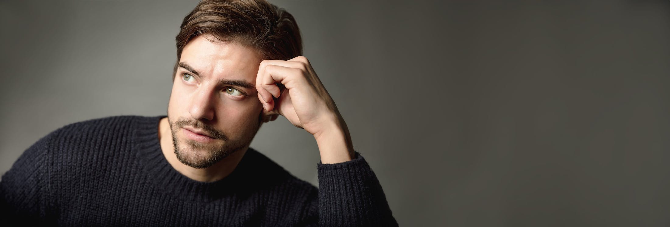 Man leaning head on hand