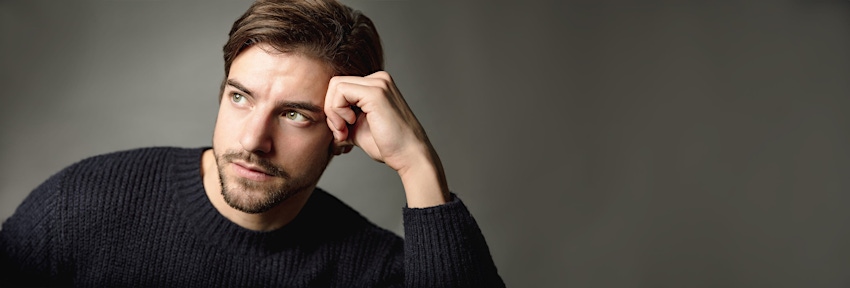 Man leaning head on hand