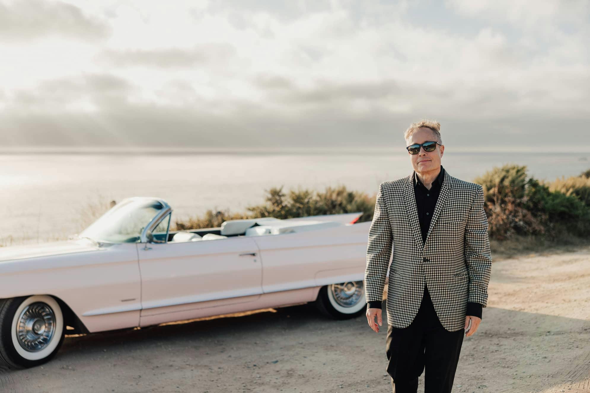 Dr. Korman Posing in Front of a Car