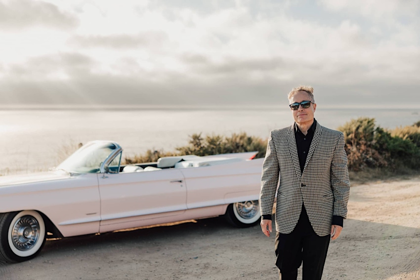 Dr. Korman Posing in Front of a Car