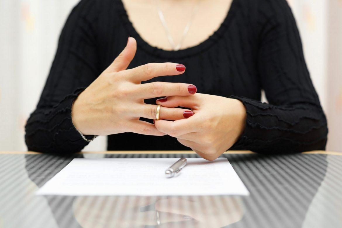 woman taking off her wedding ring