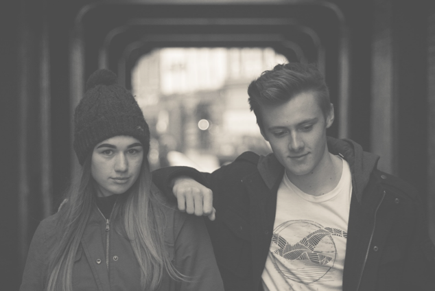 young couple with guy leaning on girl's shoulder