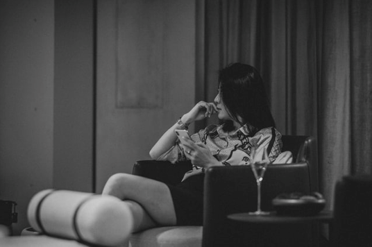 young lady sitting alone in a room thinking