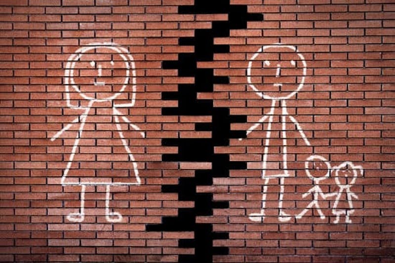 Broken wall with stick figure family on it