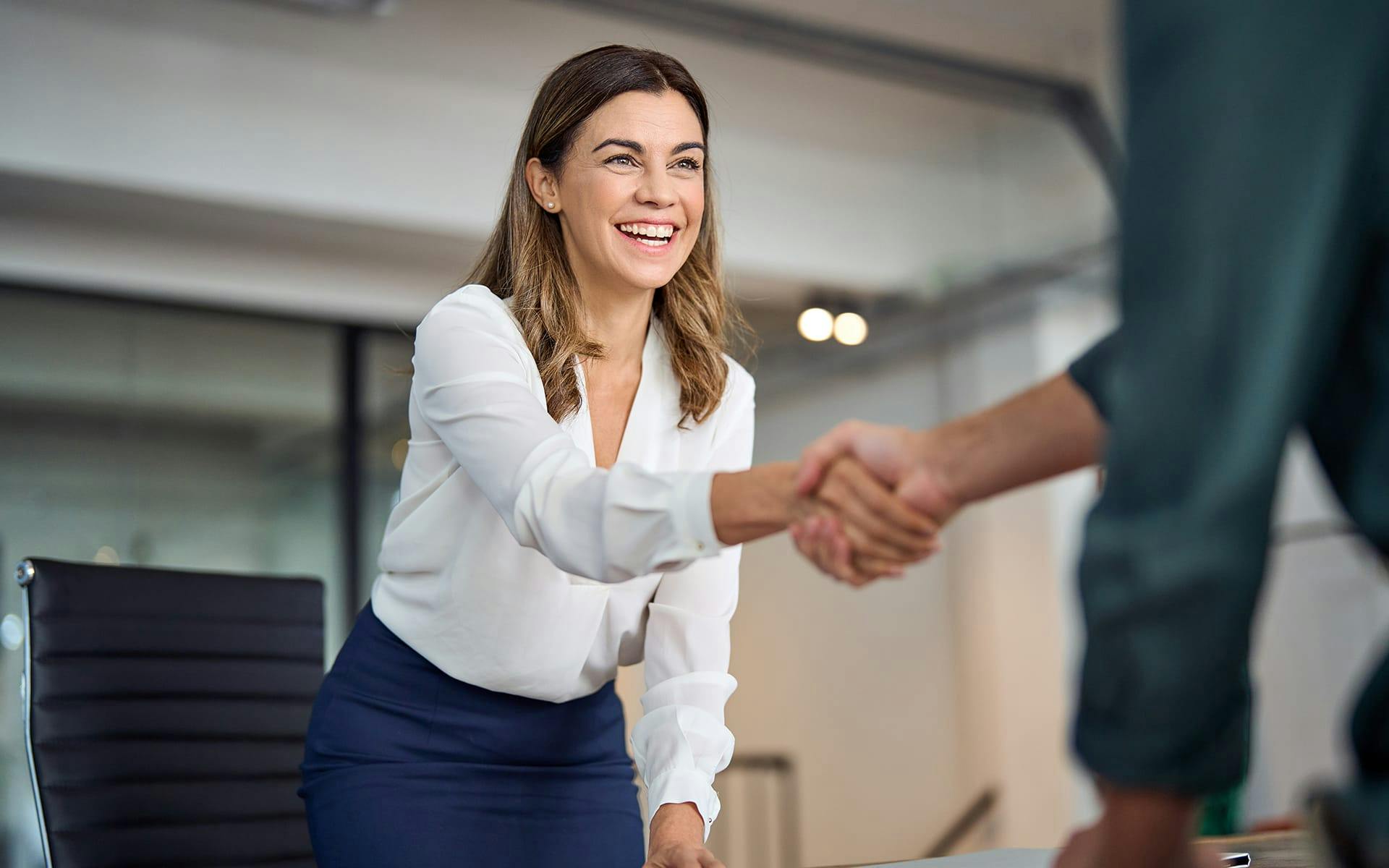 woman shaking a person hand