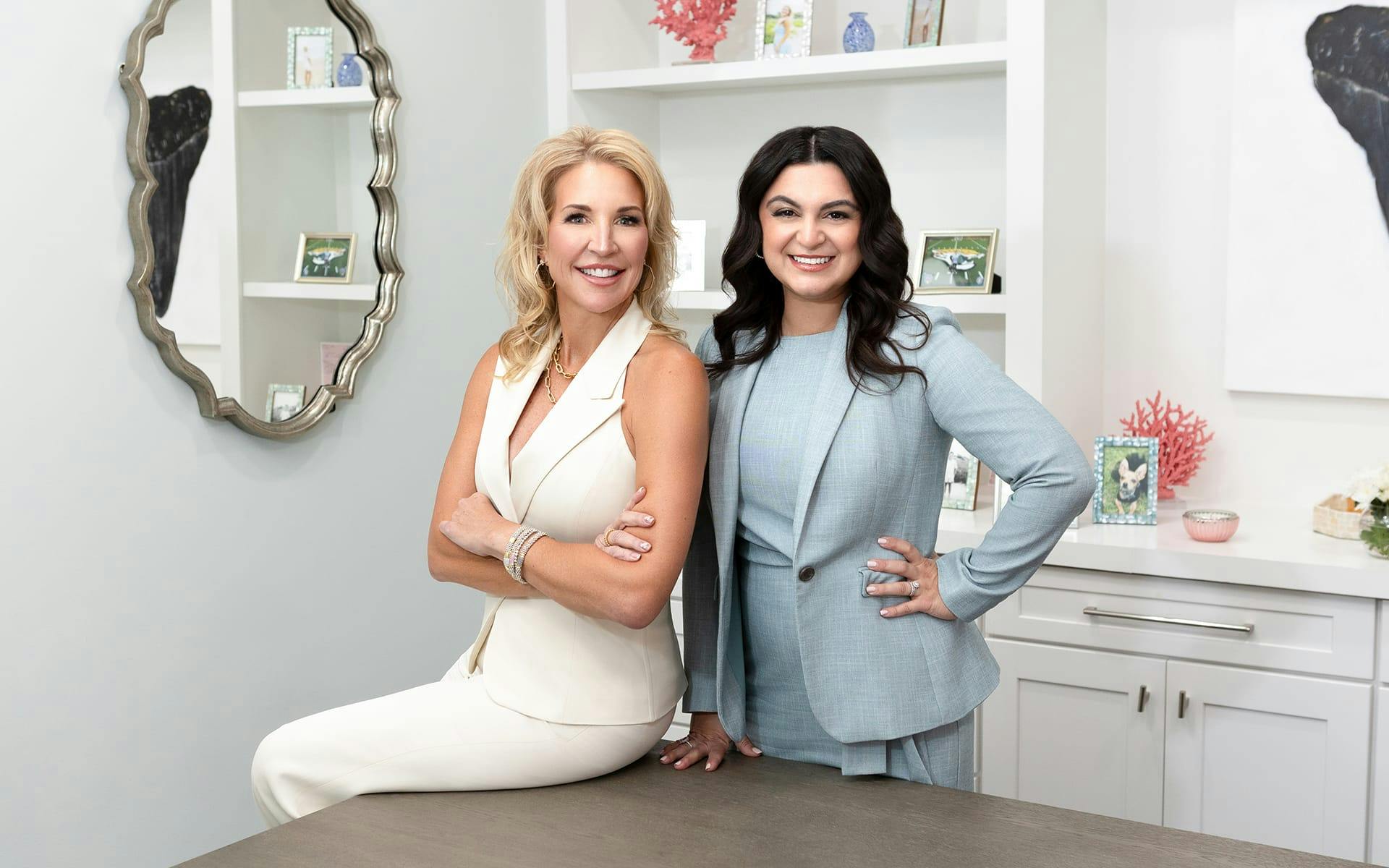 Heather Quick sitting on table and Anne posing next to her
