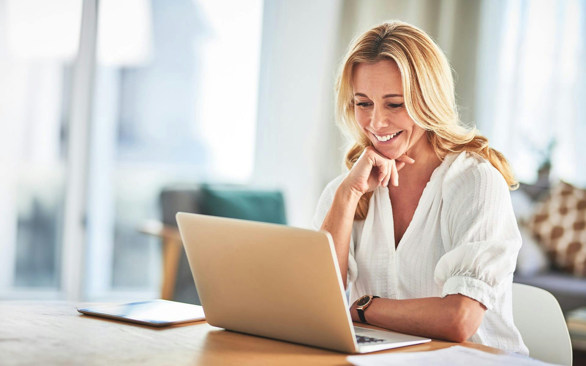 woman smiling at laptop