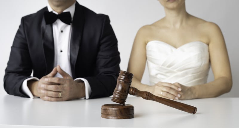 Bride and Groom sitting at table with a gavel